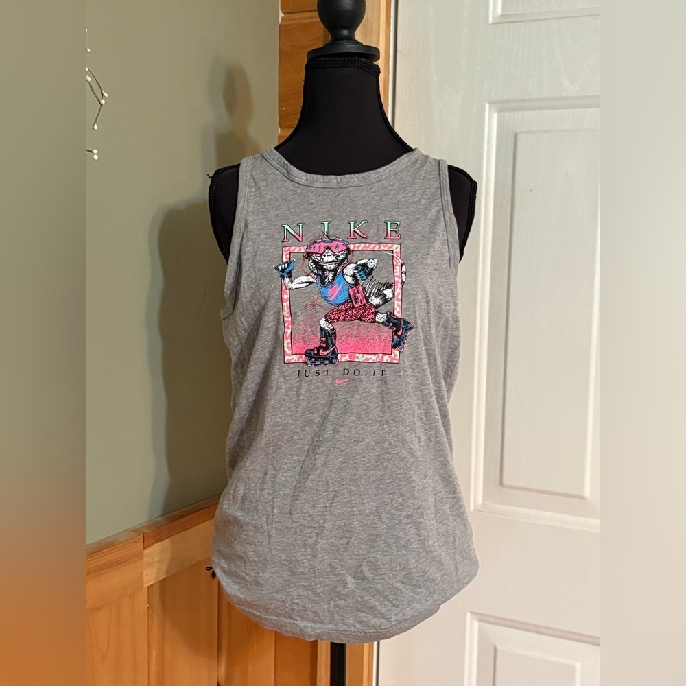 Nike youth tank with reptile rollerblading.